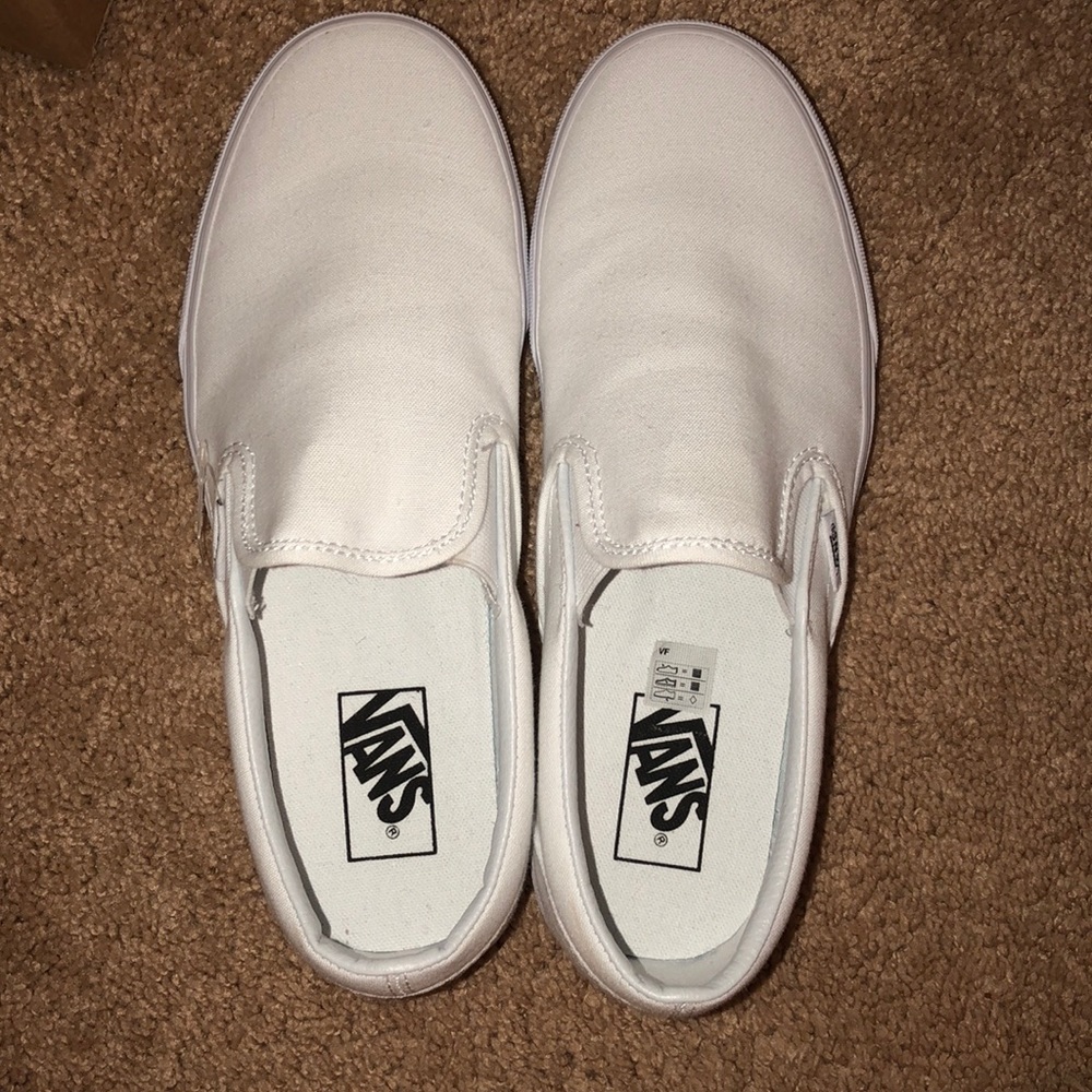 white slip on vans (excuse my ugly fingers lol))